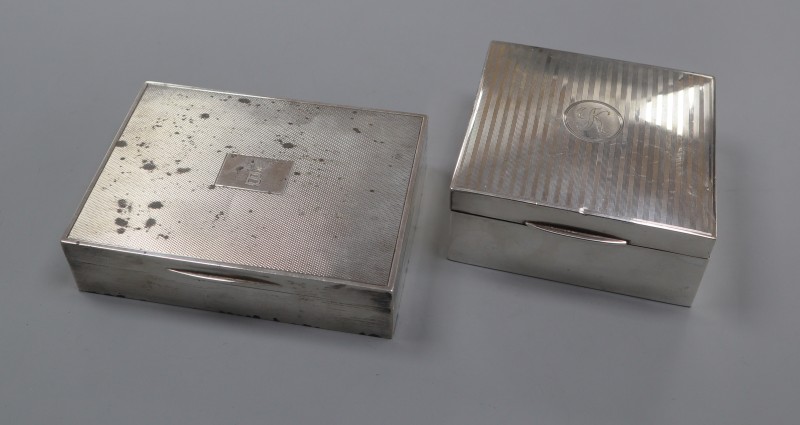 Two George V silver cigarette boxes, including engine turned by Mappin & Webb, largest 12.8cm.